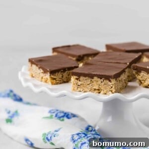 Chocolate and oat bars on a white ruffled edge cake stand.