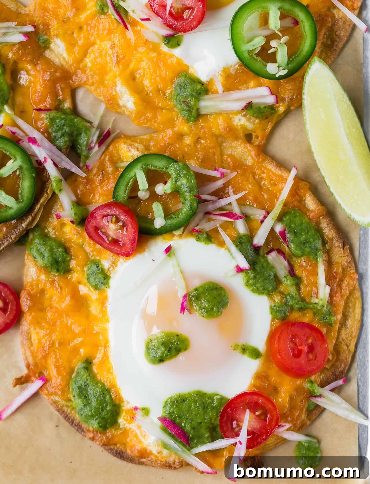 One-Pan Breakfast Tostadas 4 Beautifully arranged Sheet Pan Breakfast Tostada with a perfectly fried egg, melted cheese, salsa verde, and an assortment of fresh toppings like tomatoes and radishes.