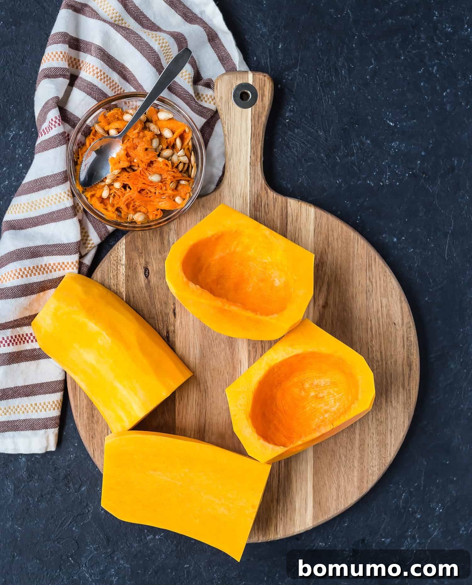 Peeled butternut squash quarters with all seeds and fibrous material cleanly removed from the cavities.