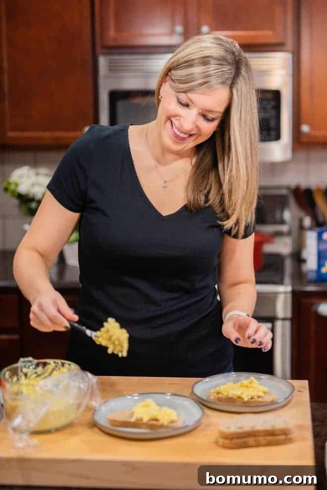 Healthy Egg Salad Makeover 3 Image of Rachel Gurk making an egg salad sandwich in her kitchen, demonstrating the easy preparation.
