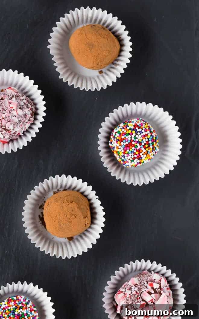 Exquisite images of brigadeiros, Brazilian fudge balls, elegantly coated in vibrant peppermint candies, rich cocoa powder, and sparkling colorful sprinkles, arranged beautifully.