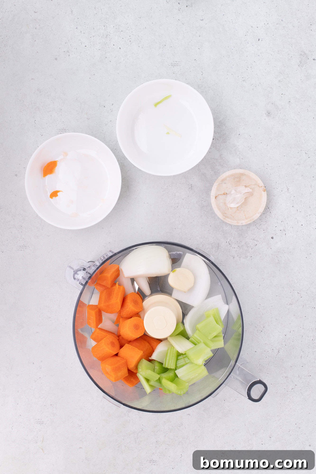 Roughly chopped onions, carrots, celery, and garlic ready for the food processor.