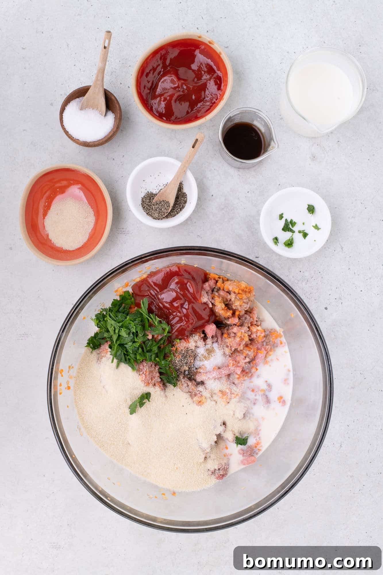All meatloaf ingredients gathered in a large mixing bowl, waiting to be combined.