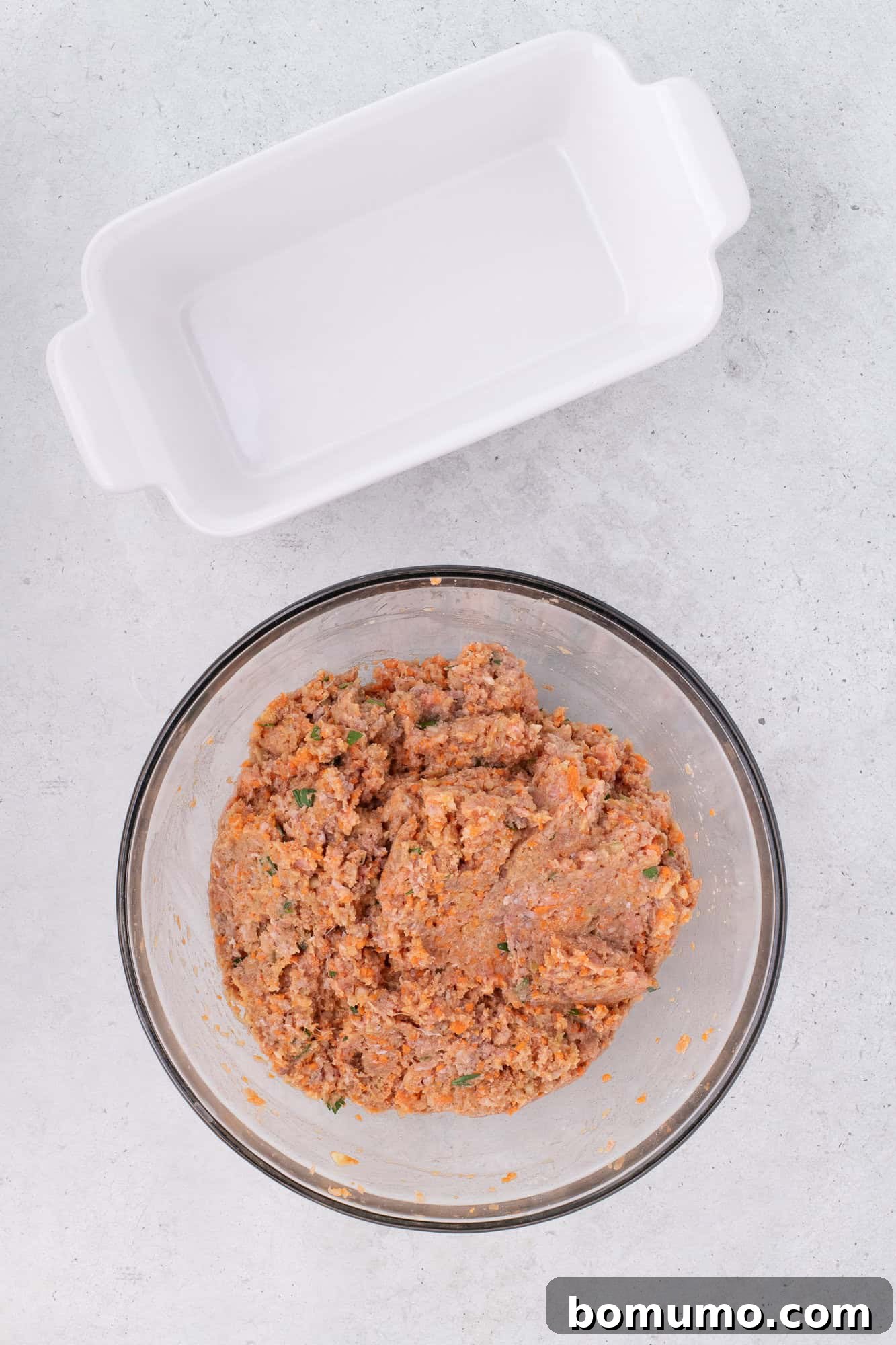 Well-mixed meatloaf mixture in a large bowl, ready for shaping.