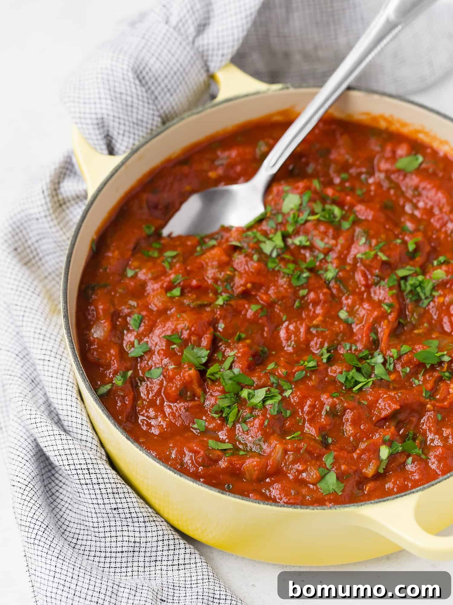 Homemade spaghetti sauce in a yellow pot.