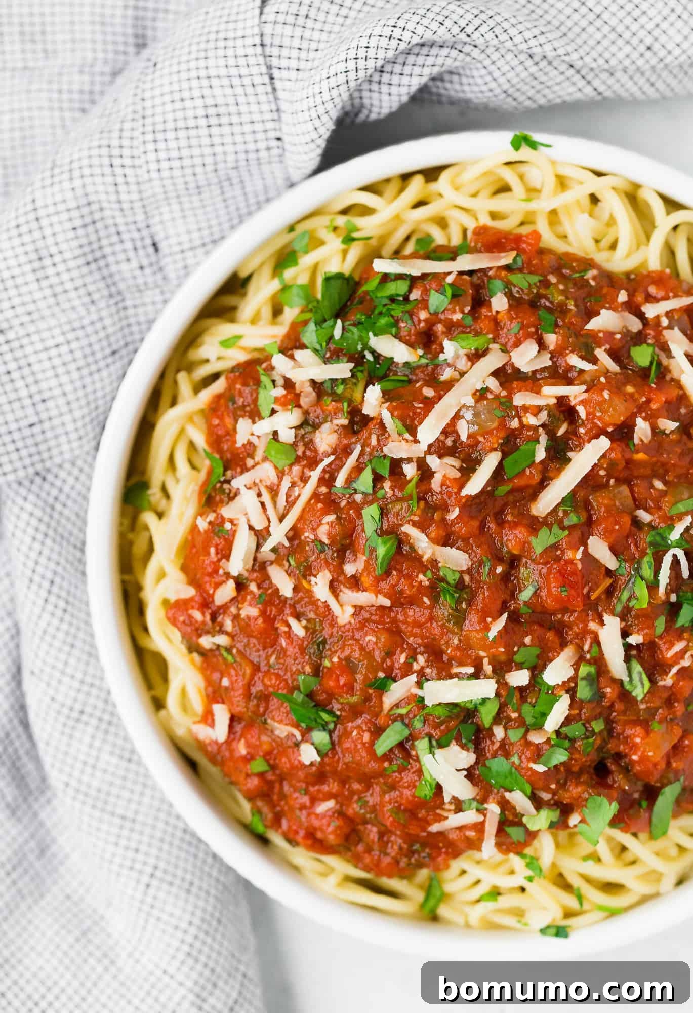 Spaghetti in a white bowl with classic marinara.