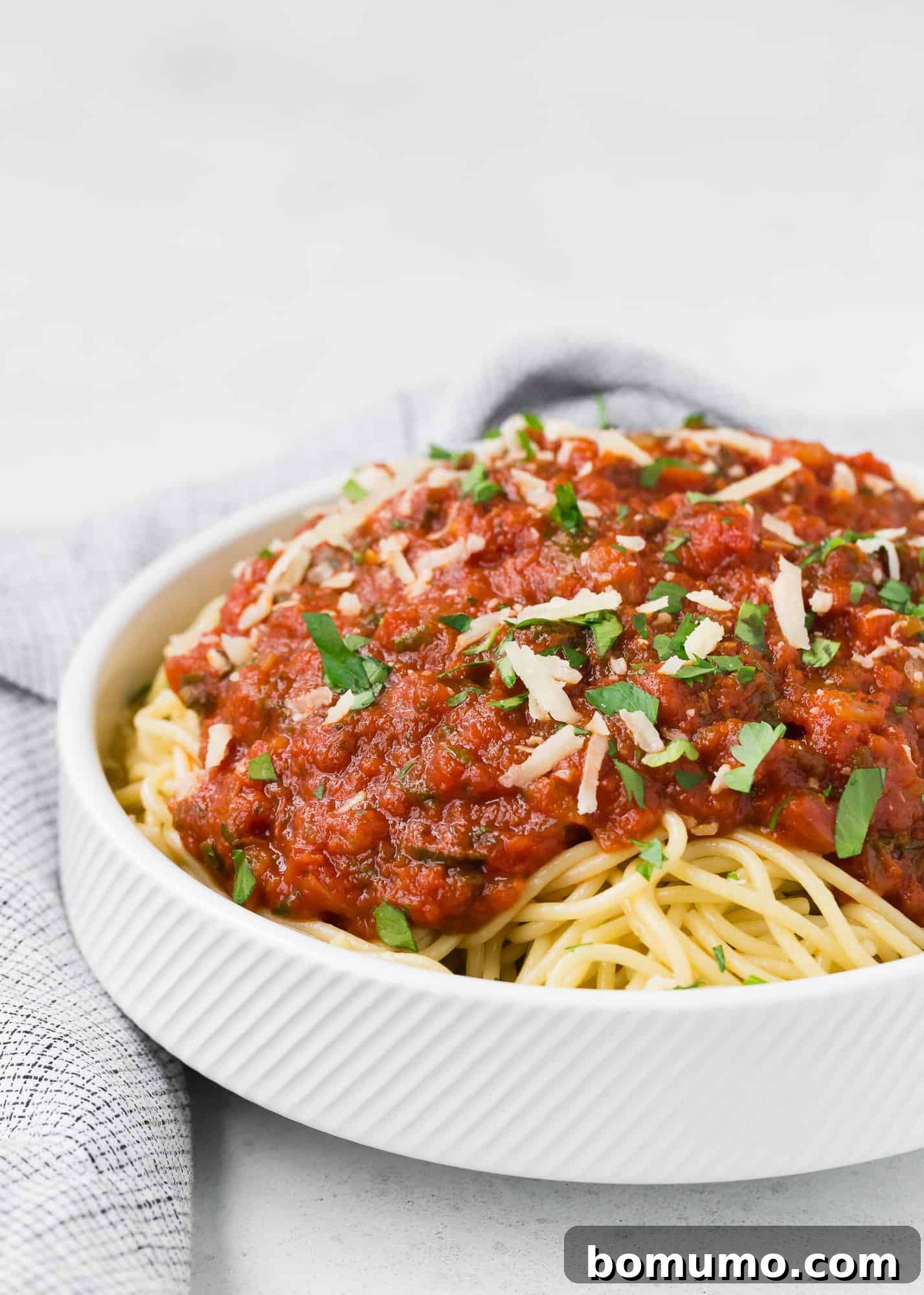 Spaghetti with spaghetti sauce and cheese.