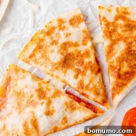 Overhead view of pizza quesadilla, cut into wedges, a super fast kid-friendly meal.