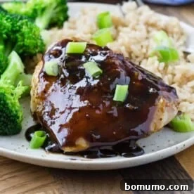 Honey balsamic chicken thigh on plate with broccoli and rice, a flavorful 5-ingredient meal.