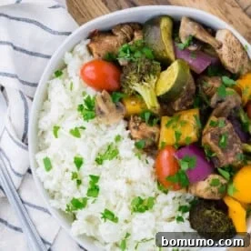 Chicken, vegetables, and rice in a bowl.