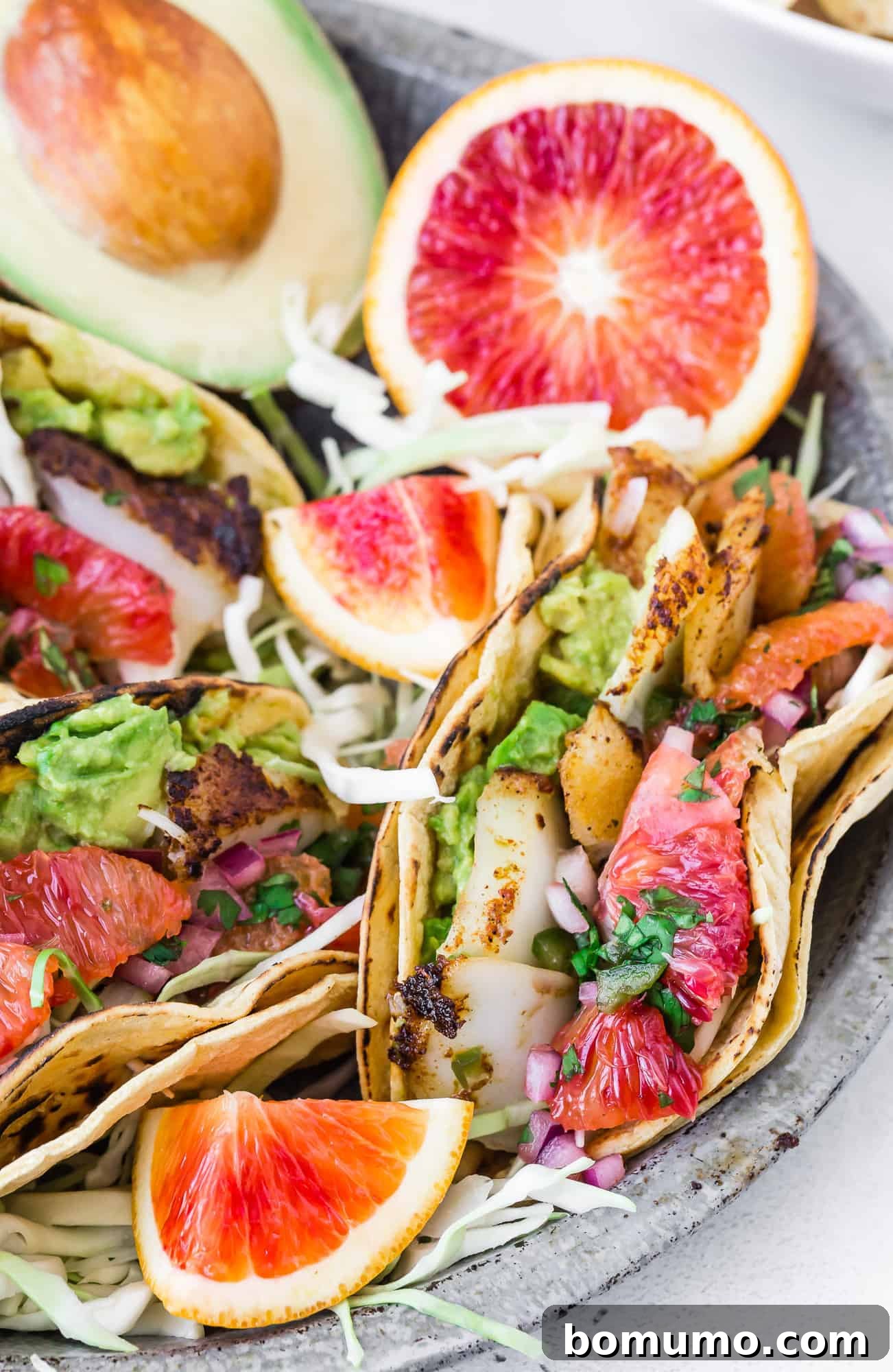 Delicious fish tacos with bright citrus salsa and creamy avocado.