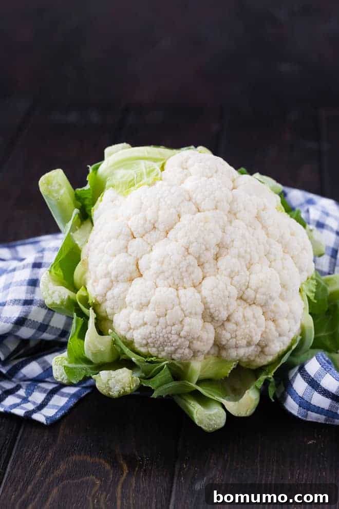 Close-up image of a fresh, vibrant head of cauliflower with its distinct, intricate florets.