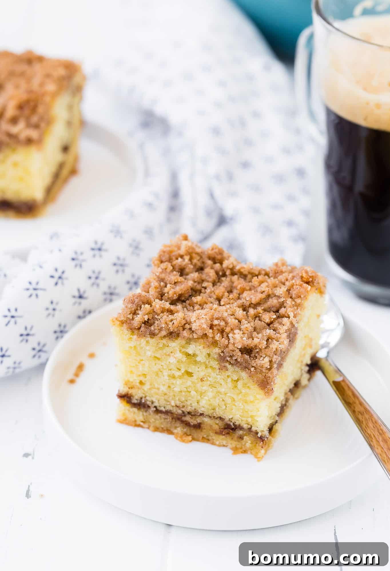 Slice of cinnamon coffee cake with streusel.