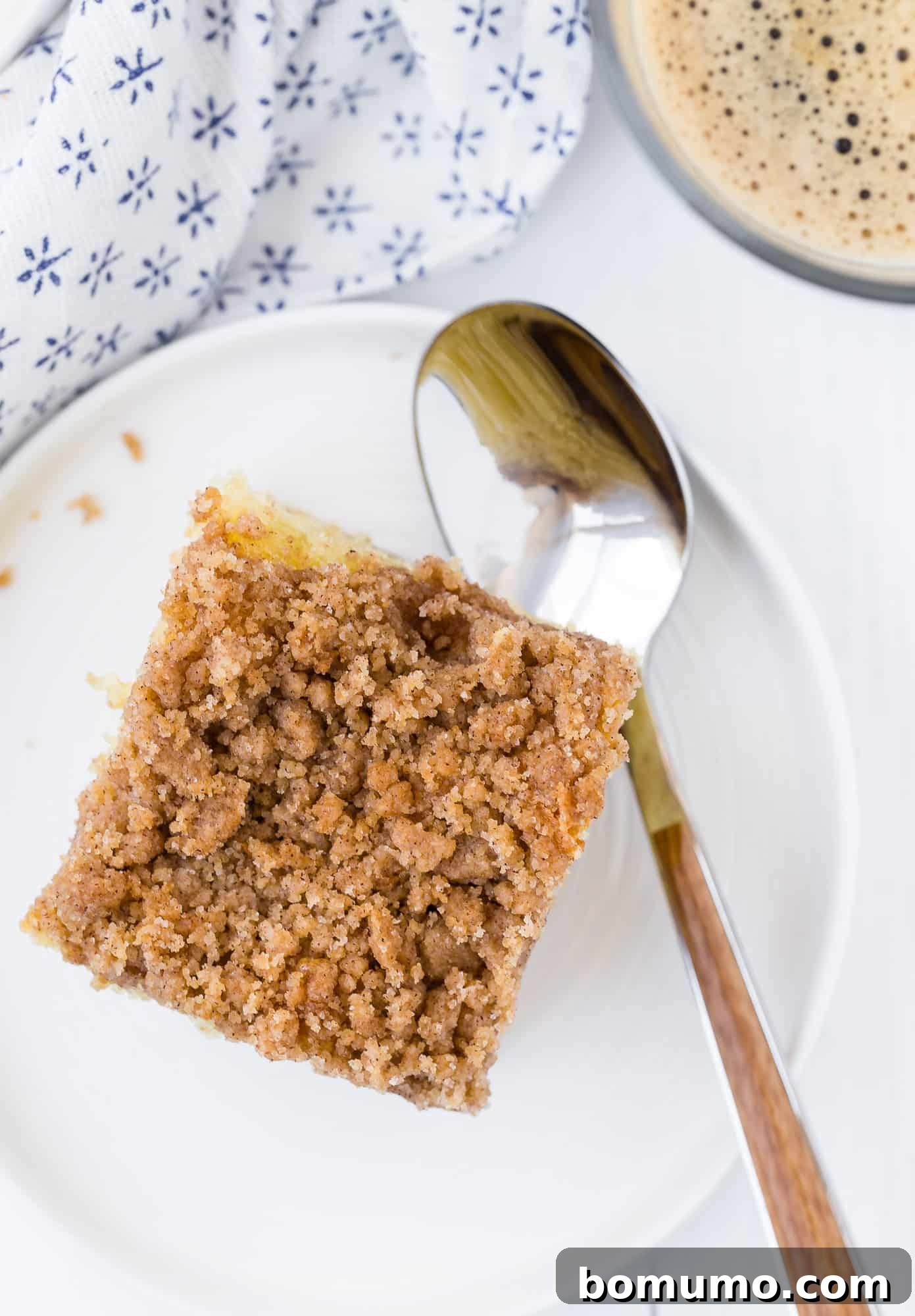 One slice of cake on a plate with a spoon.