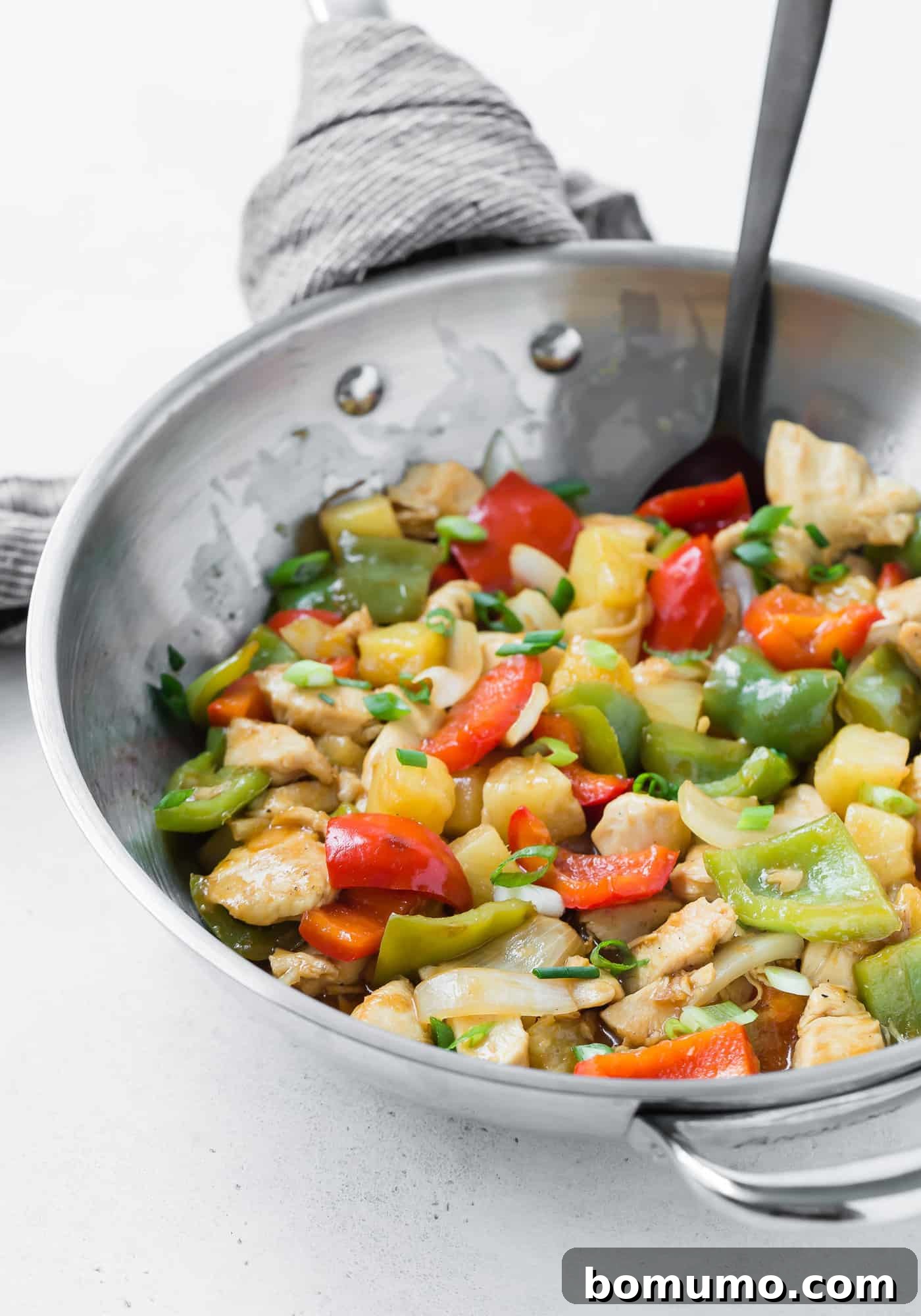 Chicken stir fry with sweet and sour sauce and vegetables.