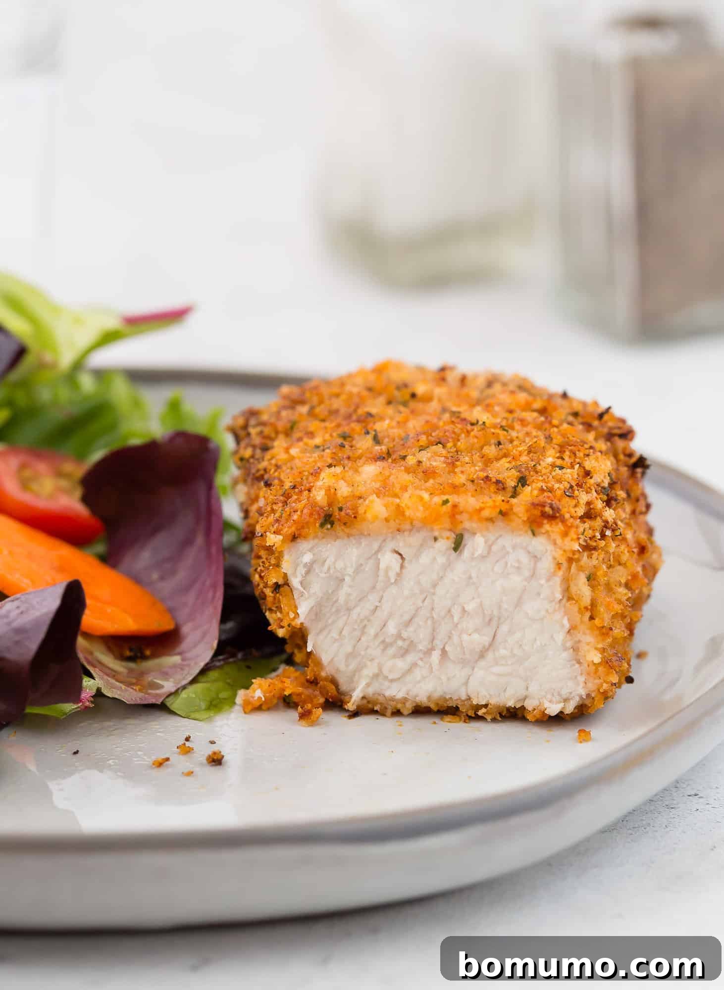 Air fryer breaded pork chop, cut to show inside.