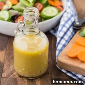 Homemade white wine vinaigrette in a small glass container, ready for serving or storage.