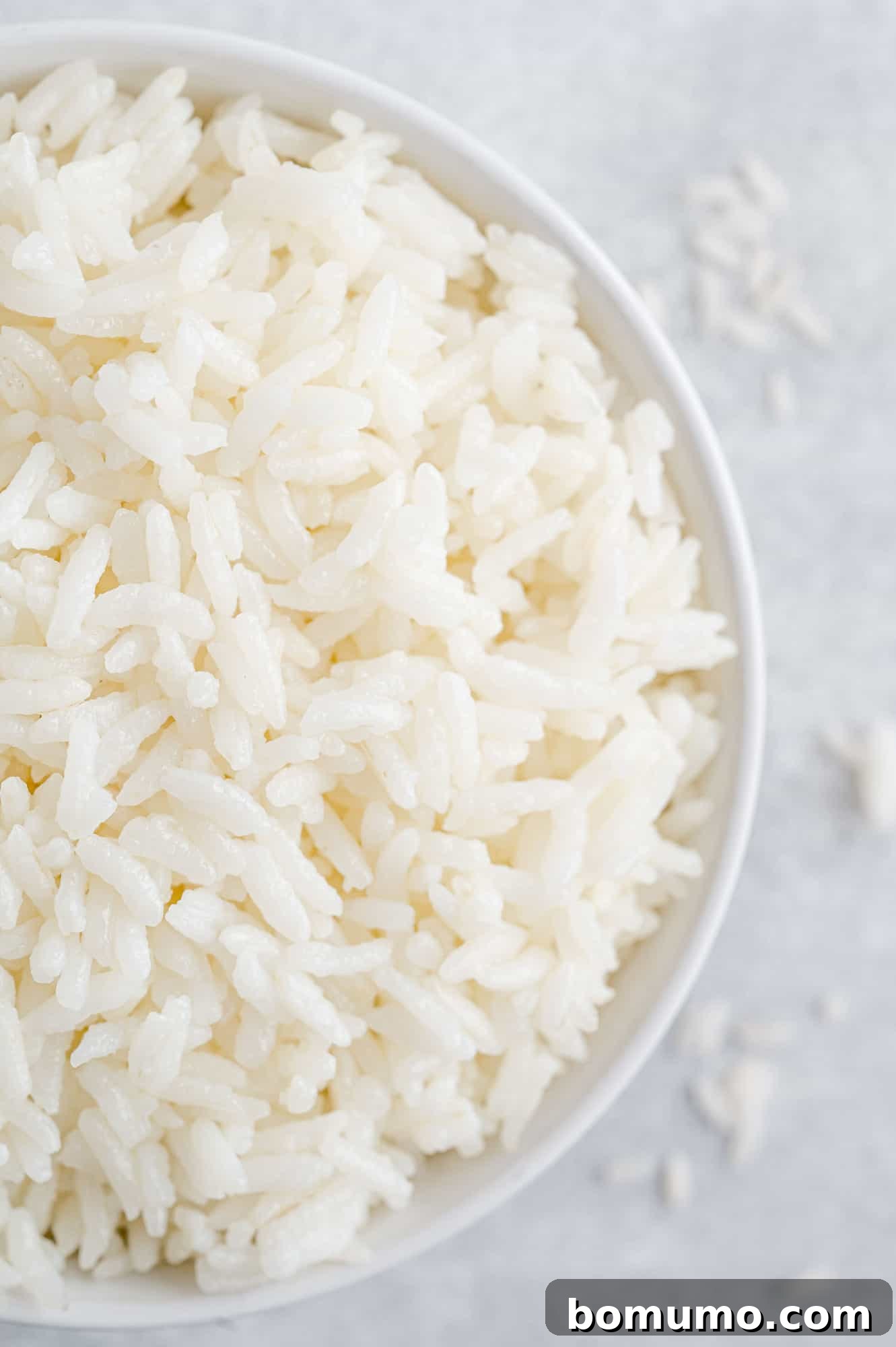 Overhead view of fluffy white rice in a bowl, ready to serve.