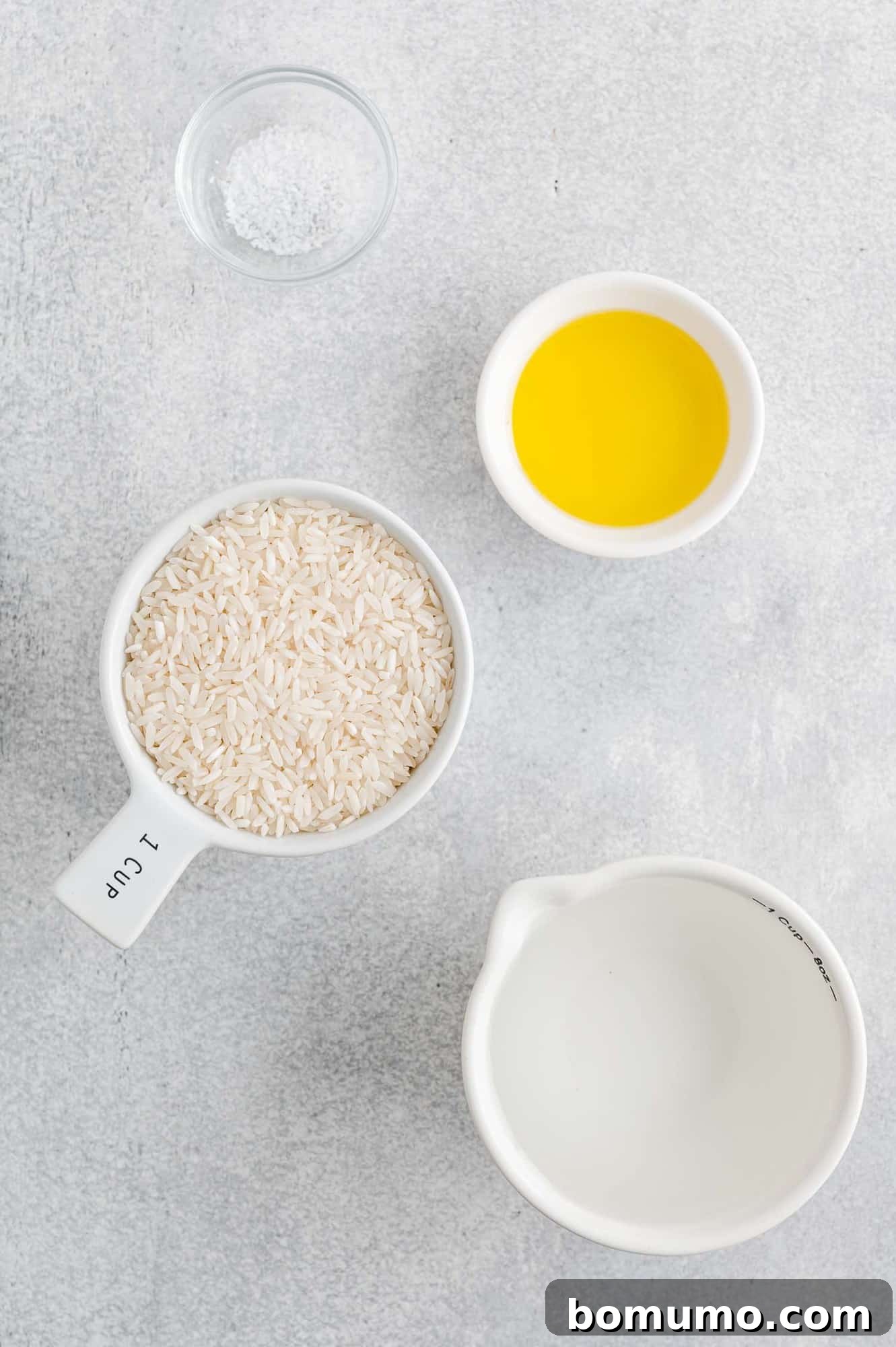Overhead view of all ingredients needed for the Instant Pot white rice recipe: rice, water, oil, and salt.