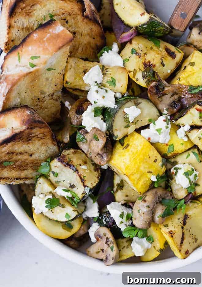 Close up of grilled zucchini, summer squash, mushrooms, and goat cheese. 