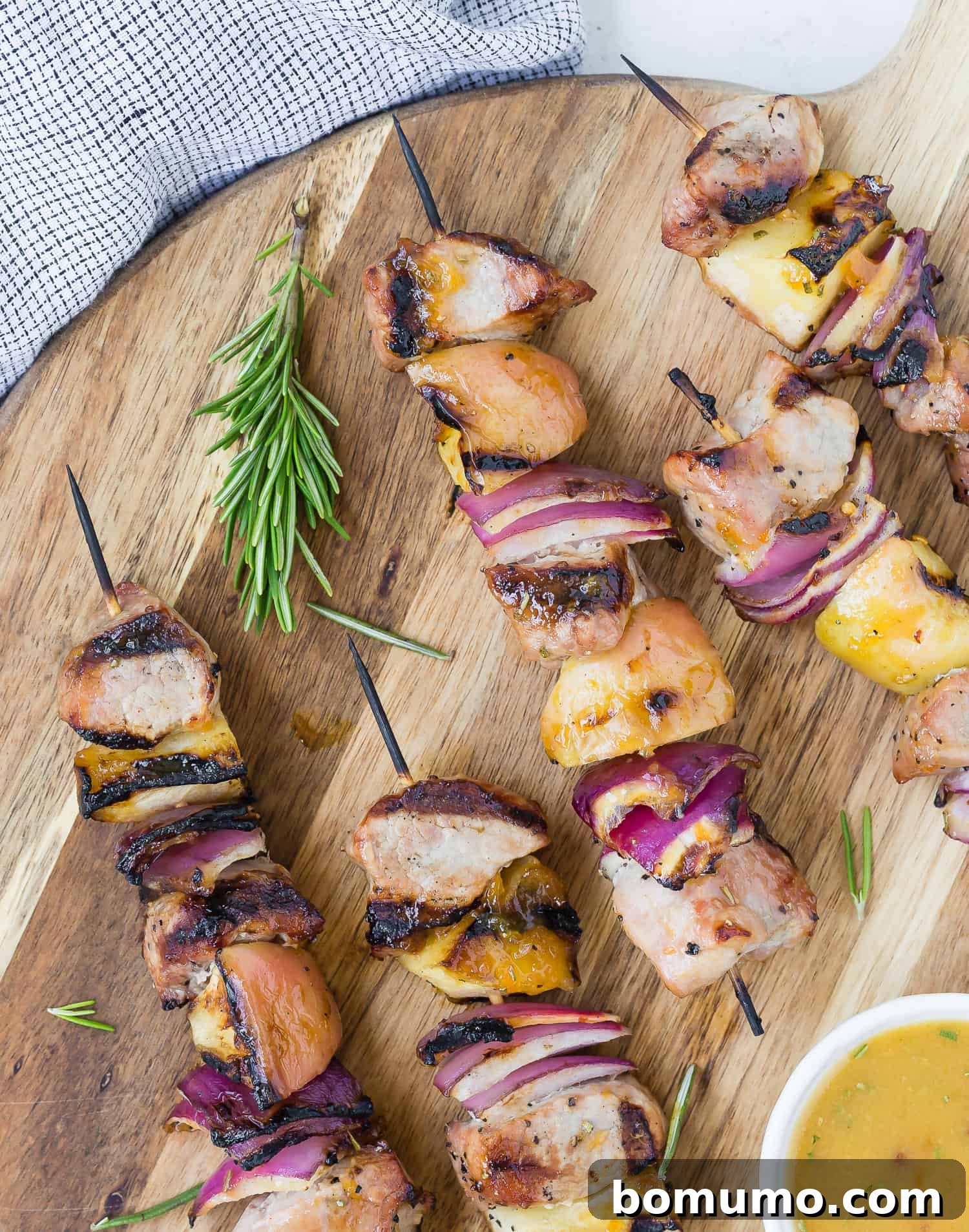 Close-up of grilled pork kebobs featuring tender pork pieces and caramelized apple chunks, ready to be served.