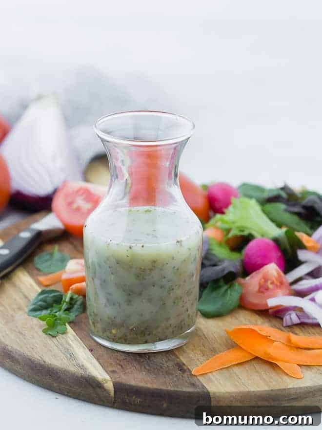Authentic Italian Dressing from Scratch 2 Small glass bottle of homemade italian dressing on wooden cutting board surrounded by colorful vegetables.