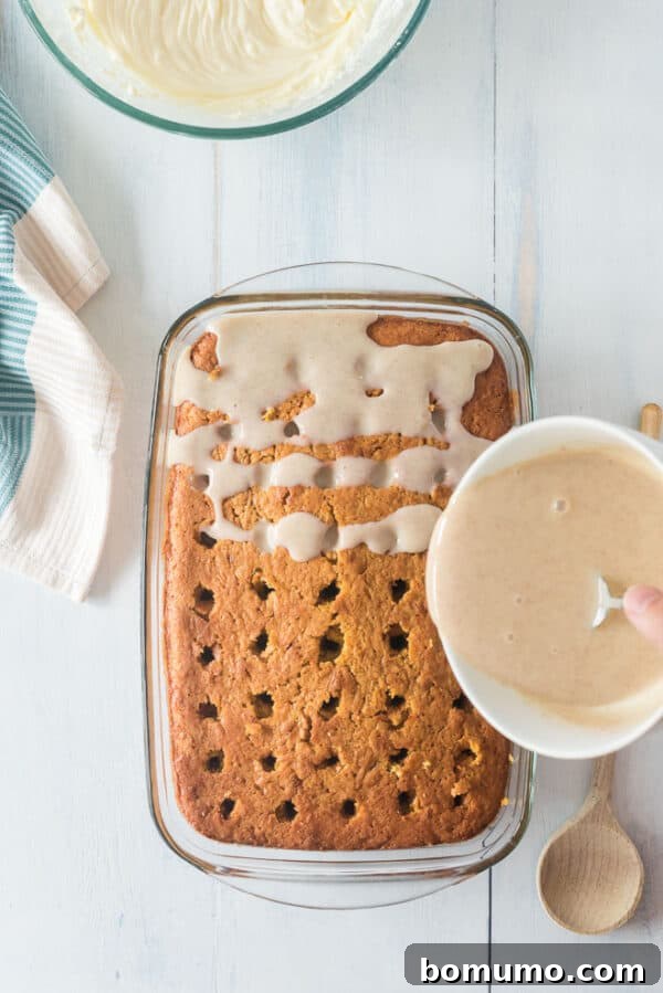 This pumpkin poke cake recipe is an easy fall dessert oozing with sweet cinnamon filling and smothered with tangy cream cheese frosting. Sweetened condensed milk seasoned with cinnamon being drizzled over a poke cake.
