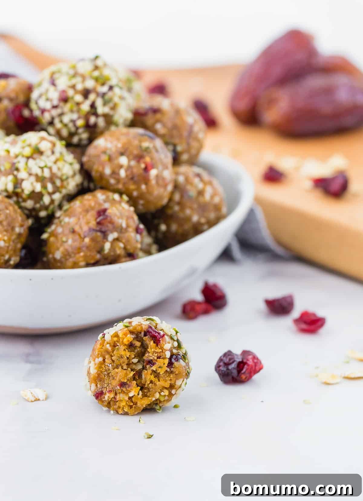 Cranberry Oat Power Bites 3 Bite taken out of a cranberry oatmeal energy ball to show texture.