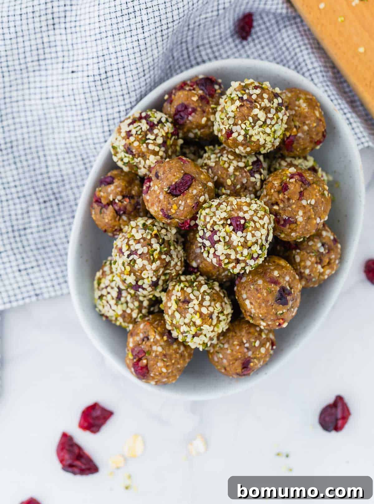 Cranberry Oat Power Bites 4 Overhead view of oatmeal energy bites in a bowl, with dried cranberries.