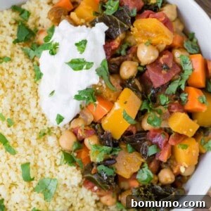 Close up overhead view of moroccan stew made with butternut squash, chickpeas and more. Served with couscous.