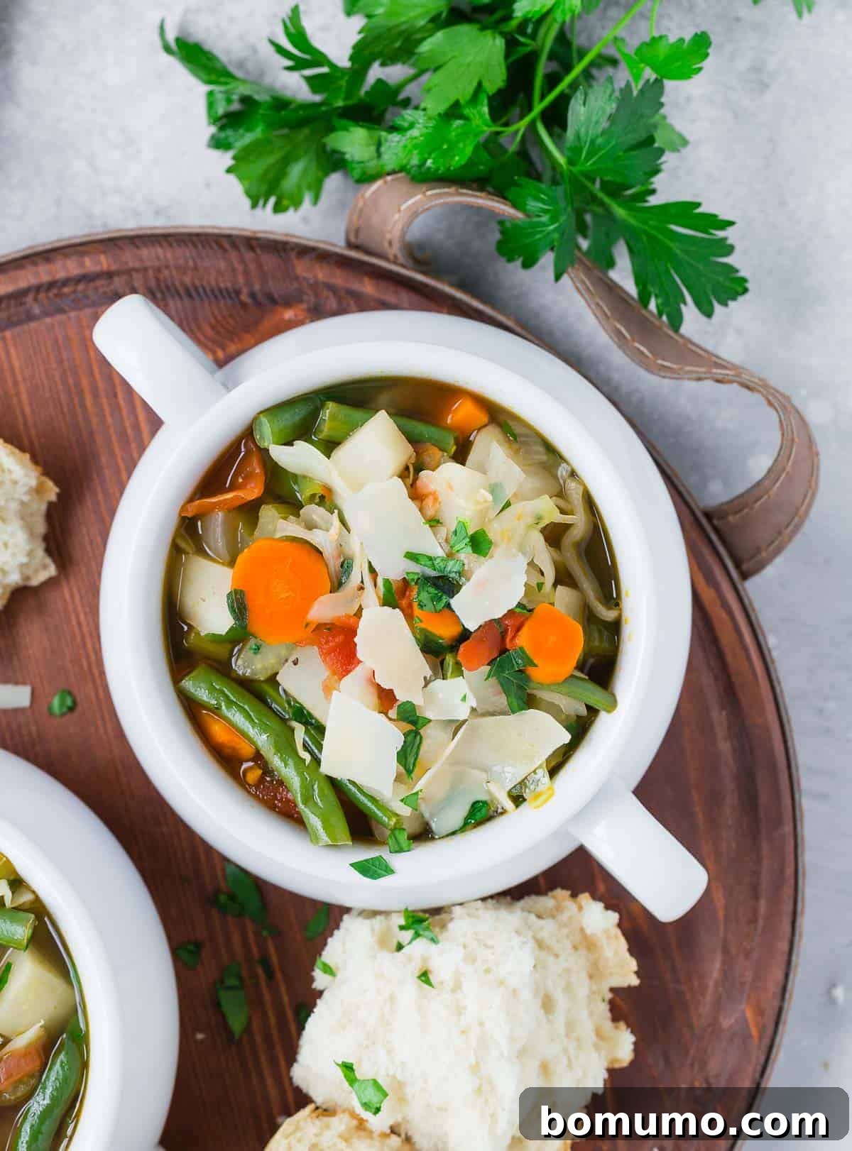 A comforting bowl of homemade vegetable soup with crusty bread, ready to be enjoyed.