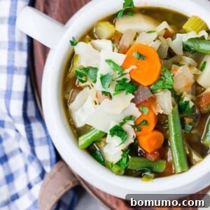 Overhead view of a bowl of color homemade vegetable soup.