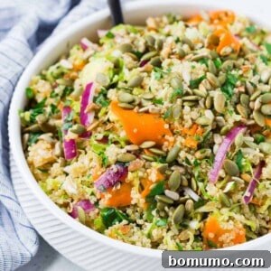 Vegan quinoa salad in a bowl, showcasing its fresh ingredients.