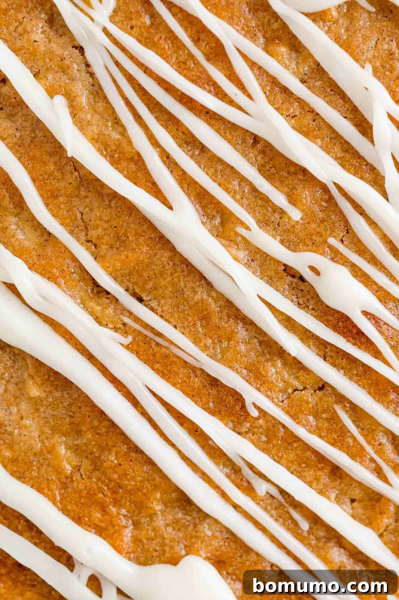 Close up of an apple spice cake drizzled with bourbon glaze.