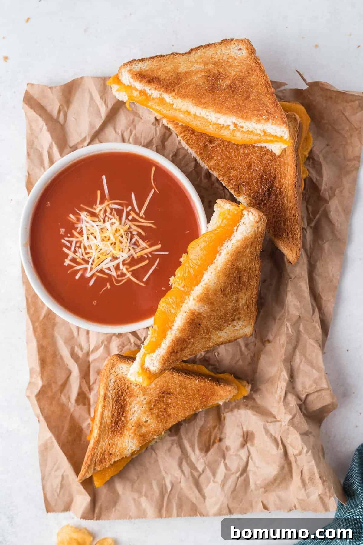 Grilled cheese sandwich halves, and tomato soup