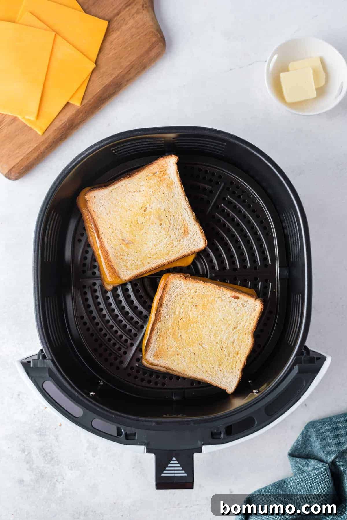 Grilled cheese being made in an air fryer.