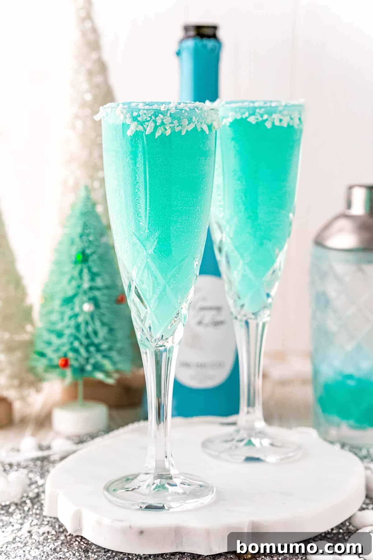 Festive bright blue drinks in elegant champagne flutes, ready for a celebration.