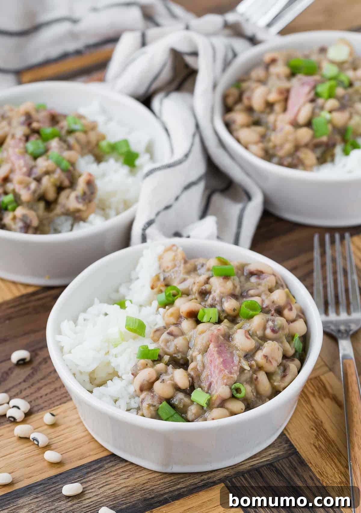 Three small white bowls of Hoppin' John. 