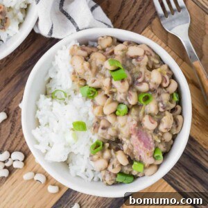 Hoppin' john in a bowl garnished with green onions.
