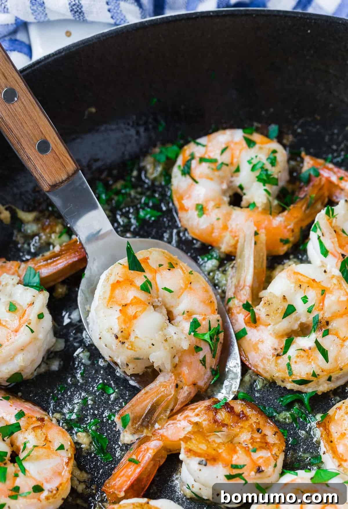 Effortless Lemon Pepper Shrimp 2 Perfectly cooked lemon pepper shrimp on a serving spoon, ready to be enjoyed.