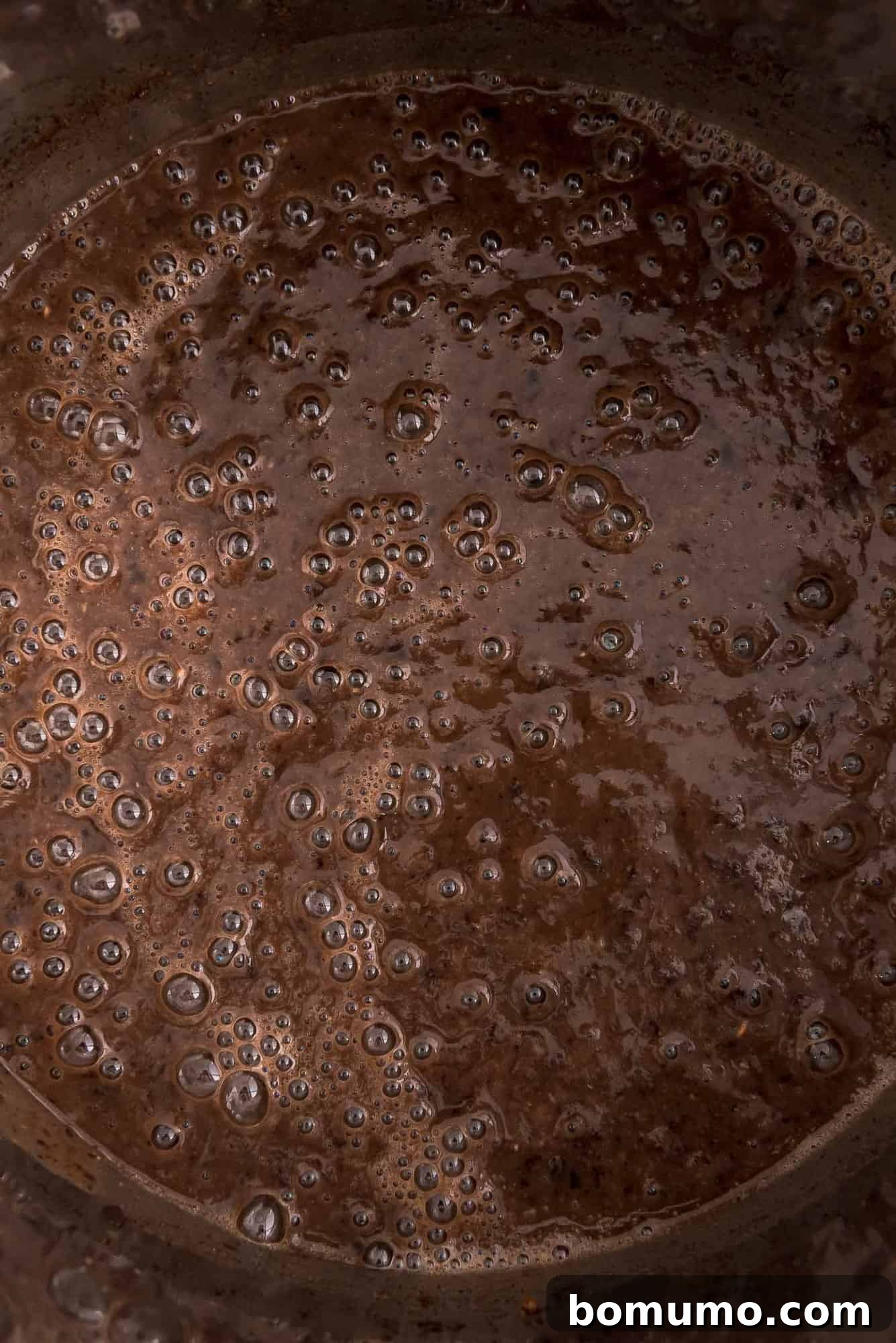 Close-up view of richly textured black bean soup simmering inside an Instant Pot, ready to be served.