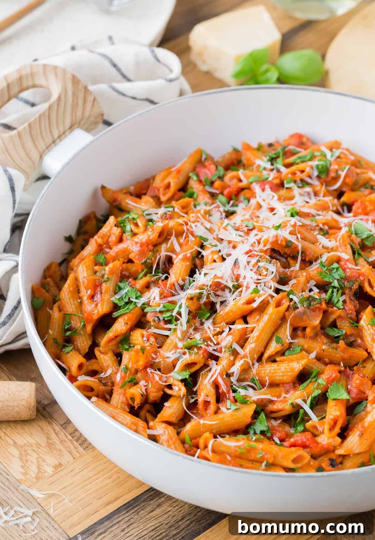 Pasta with tomato sauce in a white pan.