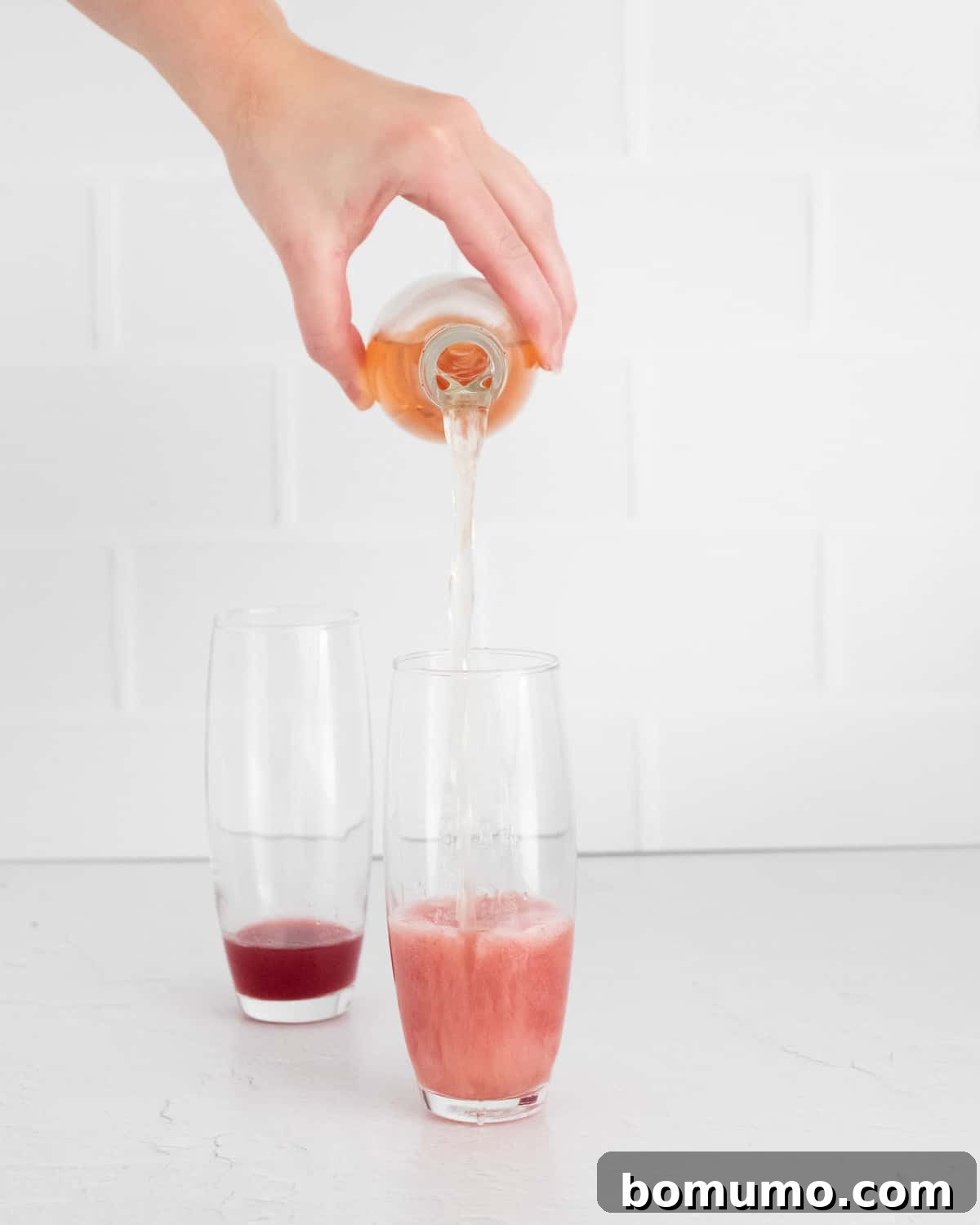 Rosé being poured into a glass, anticipating the final blend.