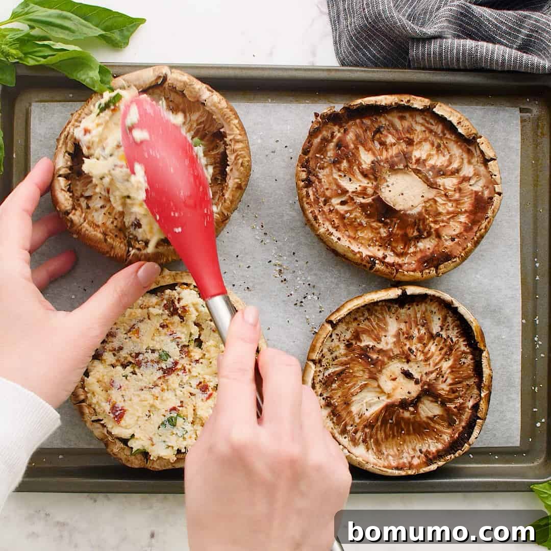 Stuffed Portobello Delight 8 Filling being placed in mushrooms.