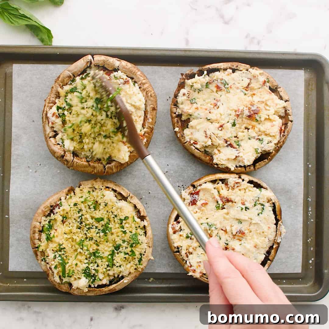 Stuffed Portobello Delight 9 Breadcrumbs being spooned onto stuffed portobello mushrooms.