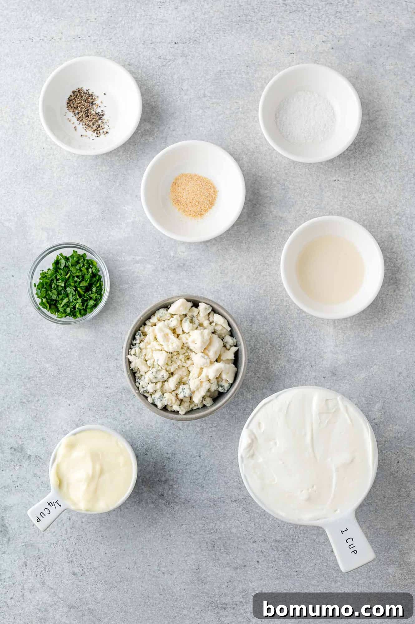 All the individual ingredients for the blue cheese dressing, perfectly portioned in separate small bowls.