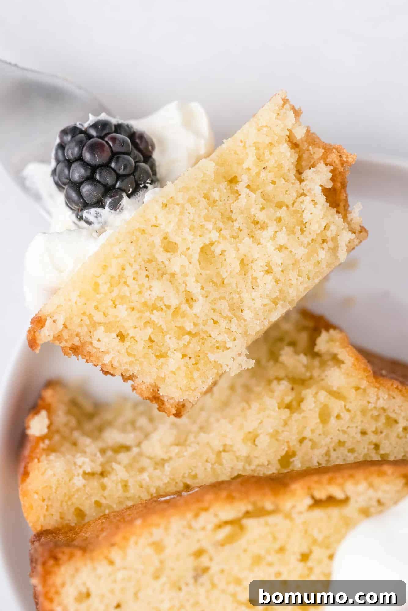 Timeless Pound Cake Perfection 13 Close-up shot of a single bite of pound cake, revealing its moist, dense texture and golden crumb, inviting a taste.