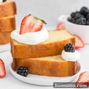 A slice of pound cake beautifully layered with fresh berries and whipped cream.