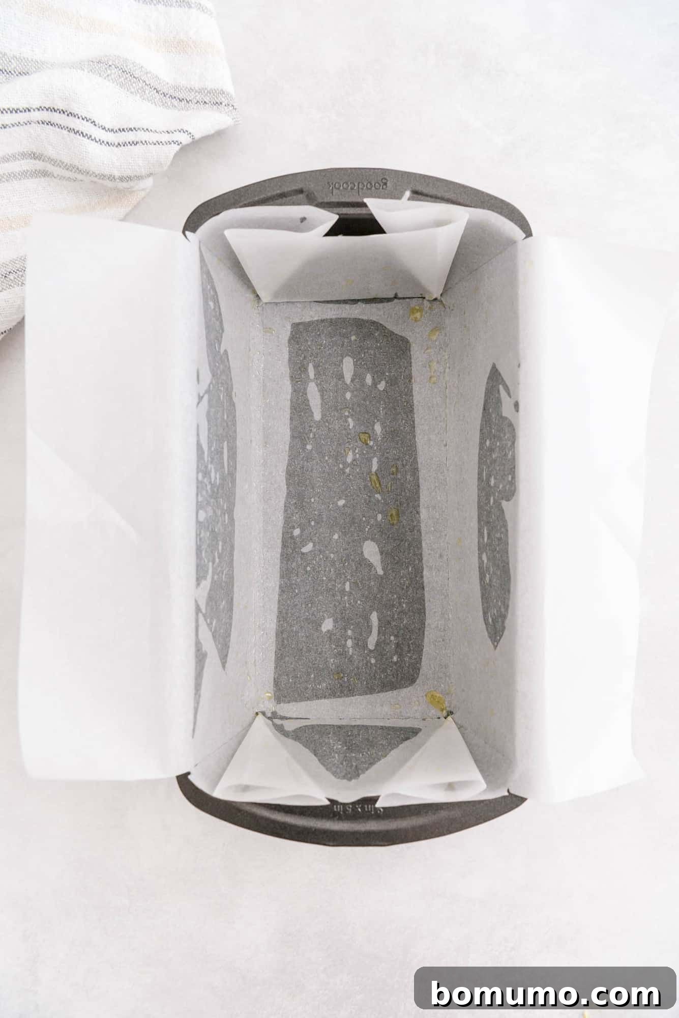 Timeless Pound Cake Perfection 5 A loaf pan meticulously lined with parchment paper, prepared for the cake batter.