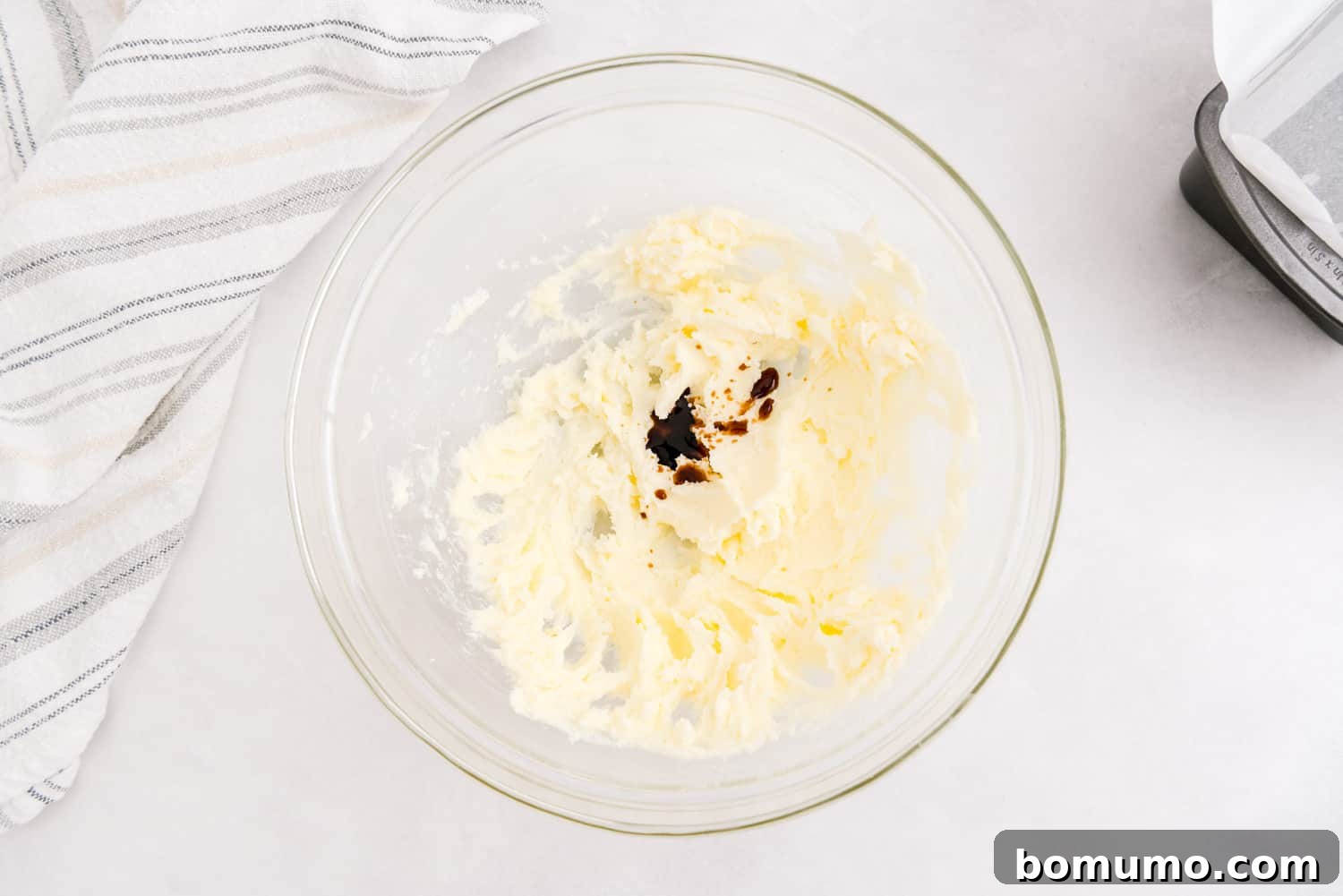 Timeless Pound Cake Perfection 6 Softened butter and granulated sugar have been creamed to a light, fluffy consistency in a mixing bowl, with pure vanilla extract just added.